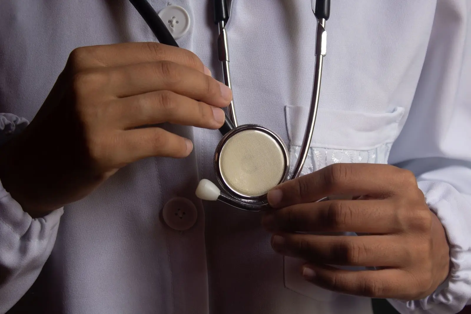 Doctor in a white coat holding a stethoscope