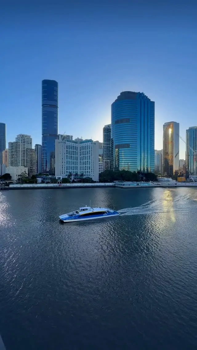 A CityCat ferry crossing the Brisbane River in front of the city skyline